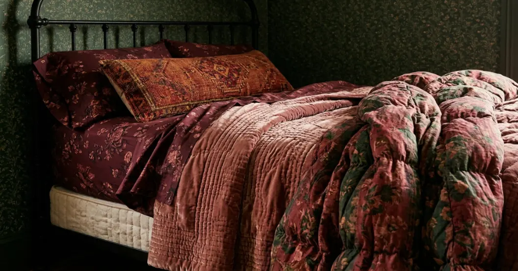 Fitted sheet folded back at a mattress and topper corner
